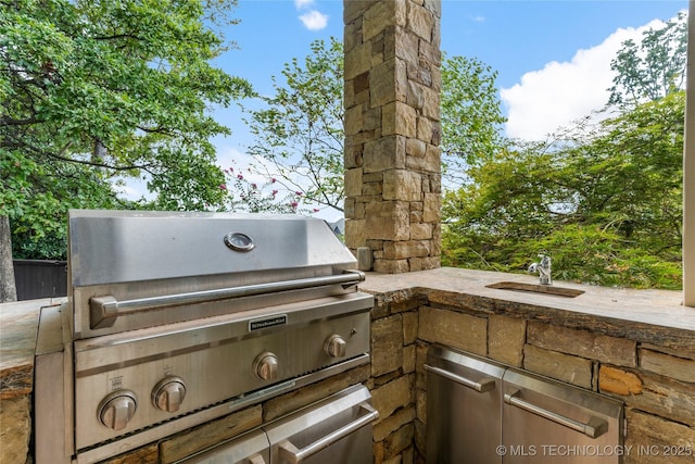 view of patio featuring a grill, sink, and exterior kitchen