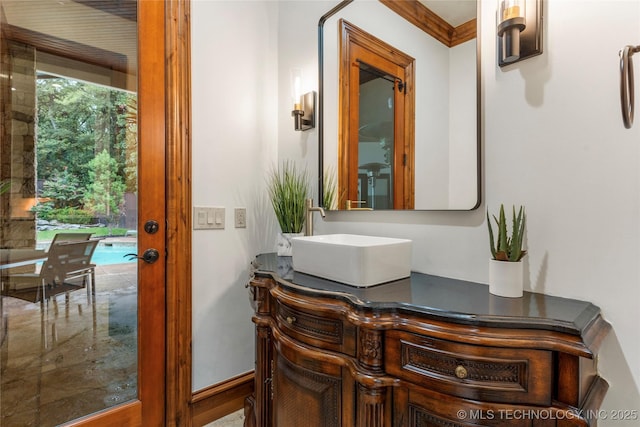 bathroom featuring vanity and ornamental molding