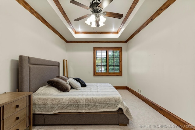 bedroom with a raised ceiling, ceiling fan, and ornamental molding