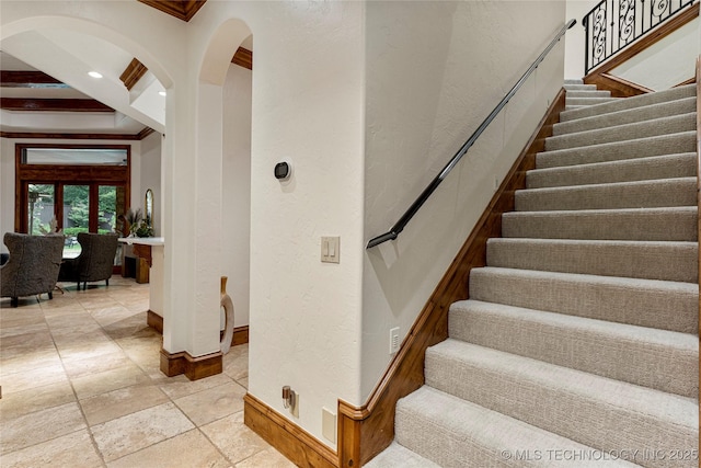 staircase featuring ornamental molding