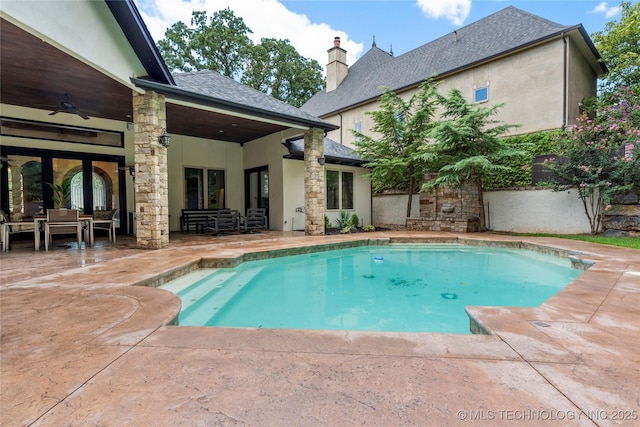 view of pool with a patio and ceiling fan