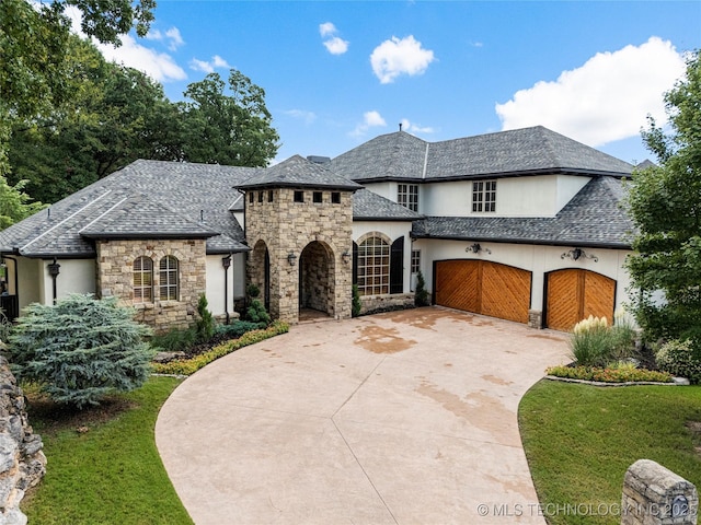 french country inspired facade with a garage and a front lawn