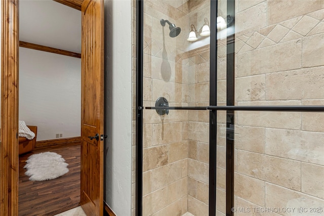 bathroom featuring a shower with door and ornamental molding