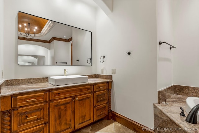 bathroom featuring vanity, ornamental molding, a tub to relax in, and a chandelier