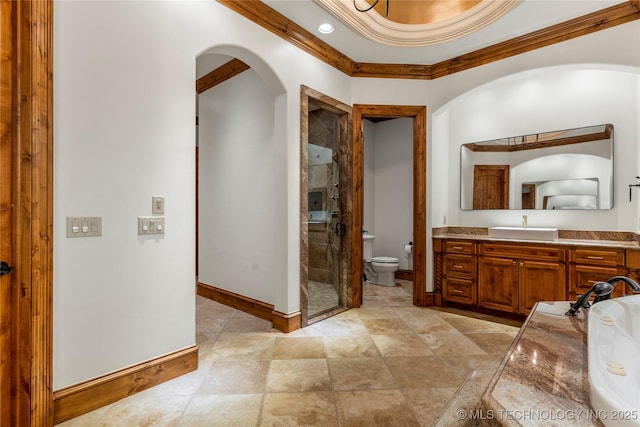 bathroom featuring vanity, toilet, ornamental molding, and walk in shower