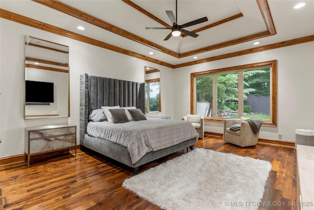 bedroom with a raised ceiling, ceiling fan, dark hardwood / wood-style floors, and ornamental molding