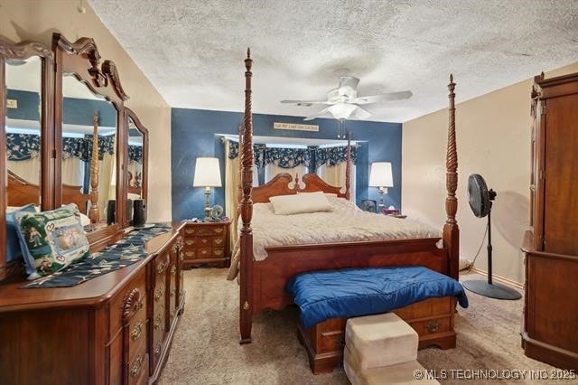 carpeted bedroom with a textured ceiling and ceiling fan