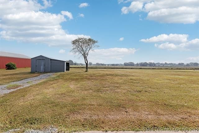 view of yard featuring an outbuilding and a rural view