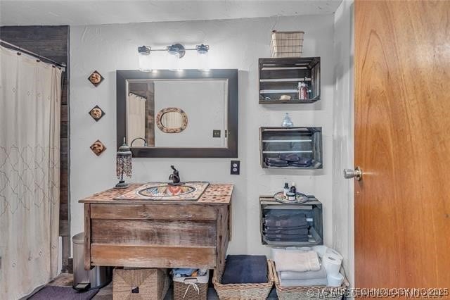 bathroom featuring curtained shower and sink