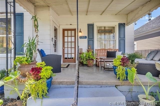 doorway to property featuring covered porch