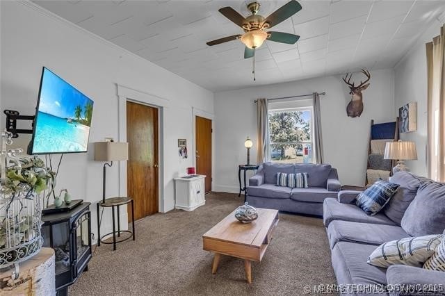 living room featuring ceiling fan and carpet