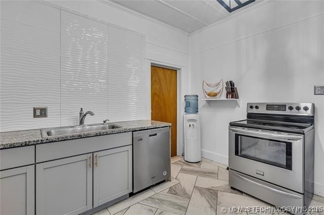 kitchen featuring gray cabinets, sink, dark stone counters, and appliances with stainless steel finishes