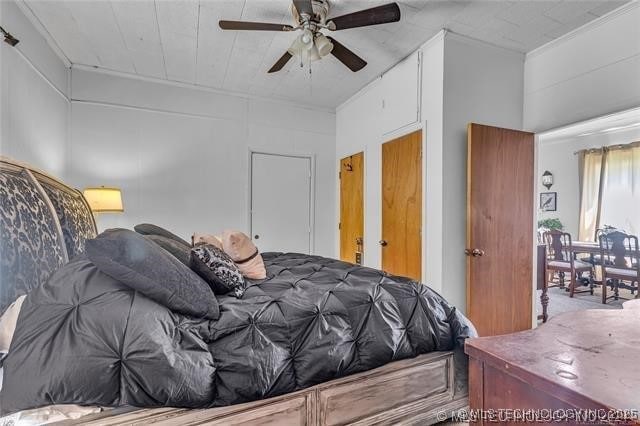 bedroom with ceiling fan and crown molding