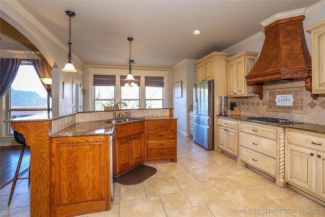 kitchen featuring a kitchen breakfast bar, custom range hood, stainless steel appliances, sink, and a large island