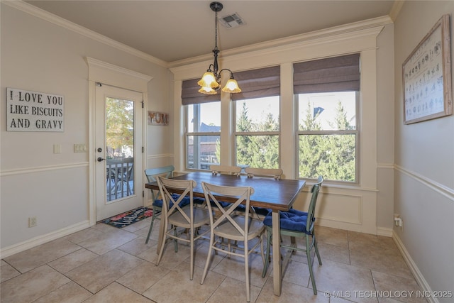 tiled dining space with crown molding and a chandelier