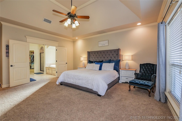 bedroom with a raised ceiling, ceiling fan, and light carpet