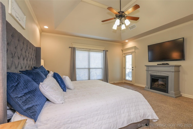 carpeted bedroom with a tray ceiling, ceiling fan, and ornamental molding