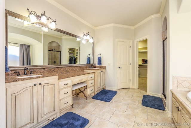 bathroom with tile patterned flooring, vanity, a shower with shower door, and ornamental molding