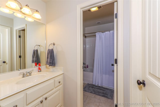 bathroom with tile patterned flooring, shower / bath combination with curtain, and vanity