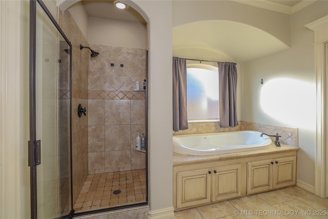 bathroom featuring tile patterned floors and independent shower and bath