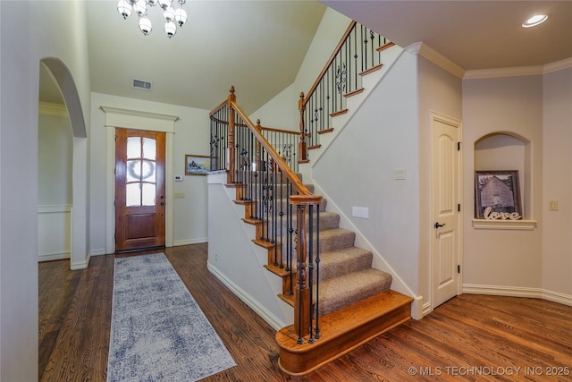 foyer featuring ornamental molding and dark wood-type flooring