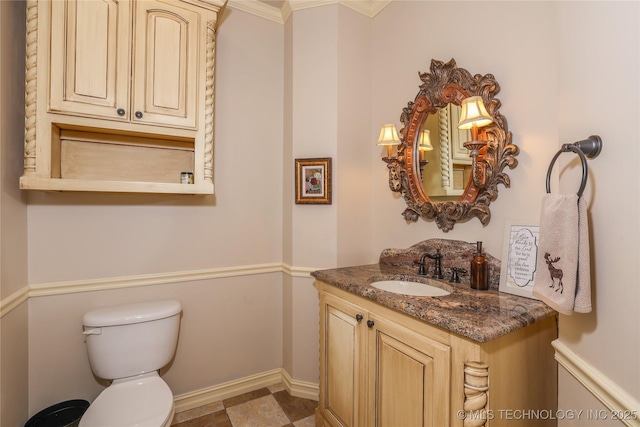 bathroom featuring vanity, toilet, and crown molding