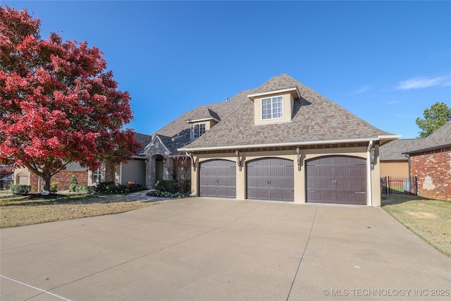 view of front facade featuring a front yard and a garage