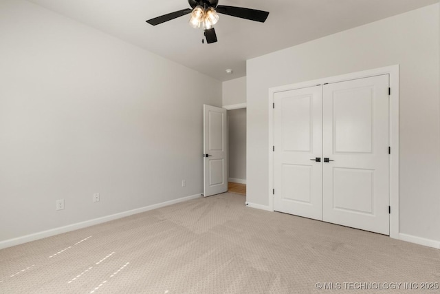 1303 Oakhurst Cir, Claremore, OK 74017 - unfurnished bedroom with light colored carpet, baseboards, a closet, and ceiling fan