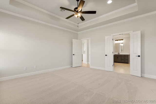 1303 Oakhurst Cir, Claremore, OK 74017 - unfurnished bedroom with a raised ceiling, light colored carpet, ornamental molding, baseboards, and ensuite bath