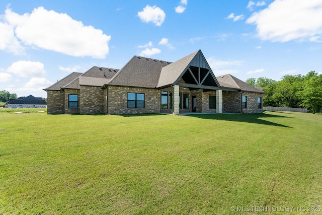 1303 Oakhurst Cir, Claremore, OK 74017 - view of front of house featuring brick siding, a front yard, and roof with shingles