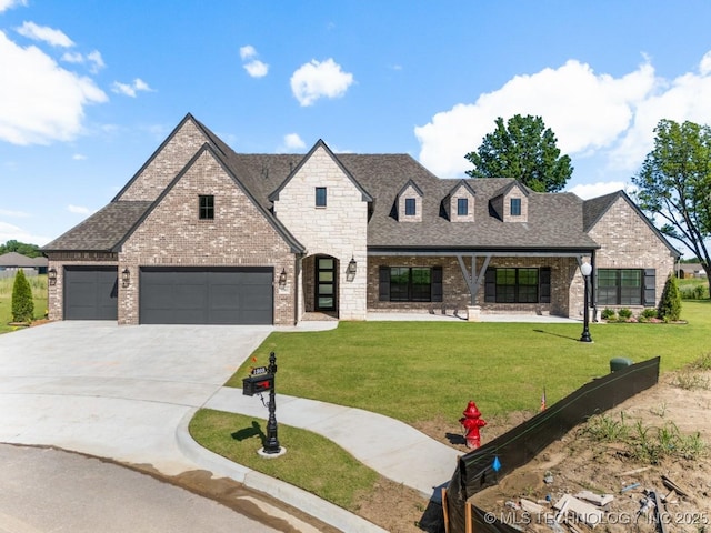 1303 Oakhurst Cir, Claremore, OK 74017 - french country style house featuring brick siding, concrete driveway, a front lawn, roof with shingles, and an attached garage