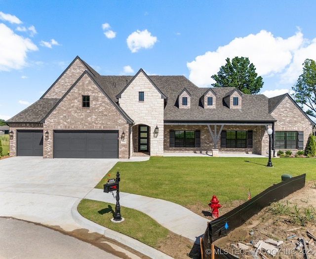 1303 Oakhurst Cir, Claremore, OK 74017 - french country style house with brick siding, driveway, a front lawn, and a shingled roof