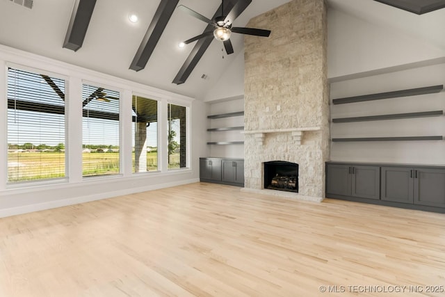 1303 Oakhurst Cir, Claremore, OK 74017 - unfurnished living room with high vaulted ceiling, light wood-style flooring, built in shelves, a stone fireplace, and a ceiling fan