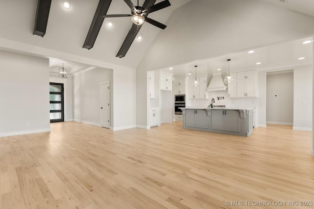 1303 Oakhurst Cir, Claremore, OK 74017 - unfurnished living room featuring high vaulted ceiling, recessed lighting, baseboards, a ceiling fan, and light wood-style flooring