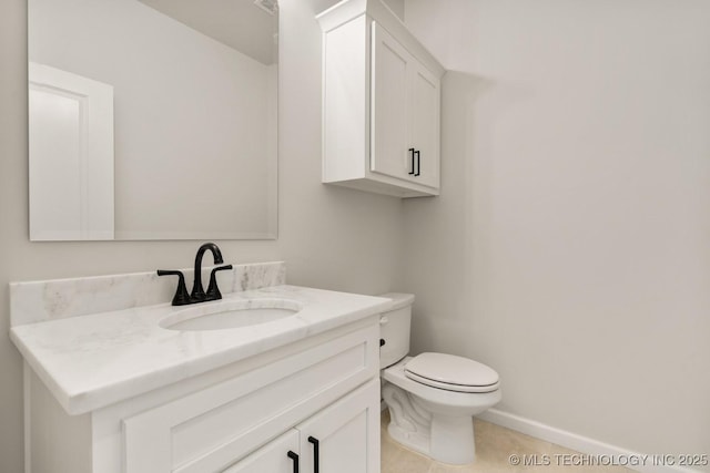 1303 Oakhurst Cir, Claremore, OK 74017 - half bathroom featuring vanity, toilet, tile patterned floors, and baseboards
