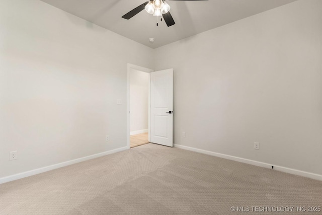 1303 Oakhurst Cir, Claremore, OK 74017 - empty room featuring light carpet, ceiling fan, and baseboards