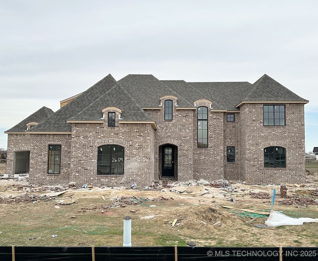 2609 Cross Creek Dr, Oologah, OK 74053 - french country home with brick siding and roof with shingles