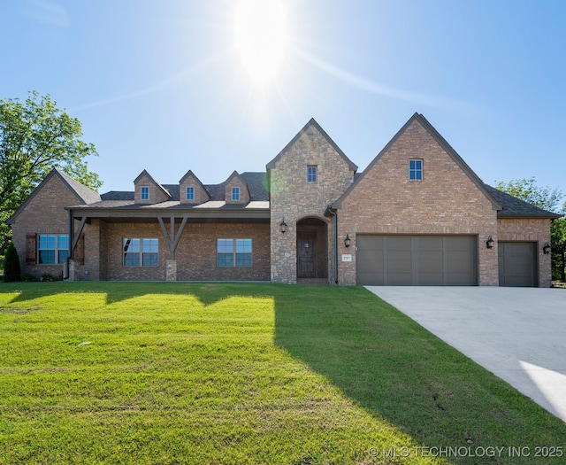 2787 Forest View Dr, Claremore, OK 74017 - view of front of property featuring brick siding, a front yard, concrete driveway, and a garage