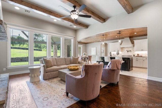 2787 Forest View Dr, Claremore, OK 74017 - living room featuring hardwood / wood-style flooring, a ceiling fan, beam ceiling, arched walkways, and recessed lighting