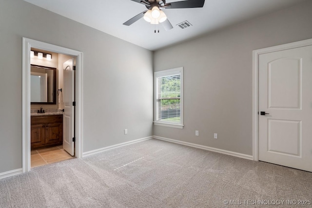 2787 Forest View Dr, Claremore, OK 74017 - unfurnished bedroom featuring light carpet, baseboards, a sink, ensuite bath, and a ceiling fan