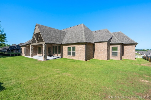 2787 Forest View Dr, Claremore, OK 74017 - rear view of house with a patio area, a yard, roof with shingles, and brick siding