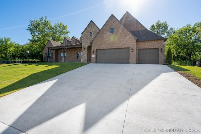 2787 Forest View Dr, Claremore, OK 74017 - view of front facade with brick siding, concrete driveway, a front lawn, and a garage