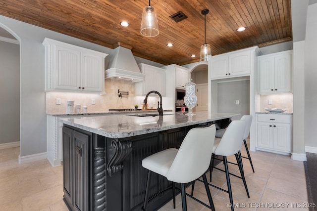 2787 Forest View Dr, Claremore, OK 74017 - kitchen with wood ceiling, premium range hood, white cabinets, tasteful backsplash, and a sink