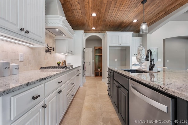 2787 Forest View Dr, Claremore, OK 74017 - kitchen with stainless steel appliances, wood ceiling, a sink, premium range hood, and arched walkways