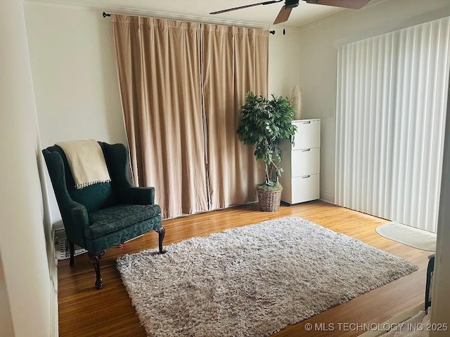 sitting room with hardwood / wood-style flooring and ceiling fan