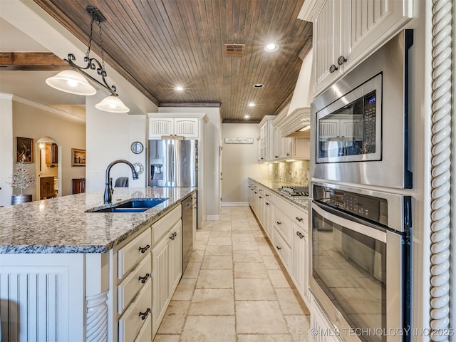 kitchen with stainless steel appliances, sink, pendant lighting, wooden ceiling, and an island with sink