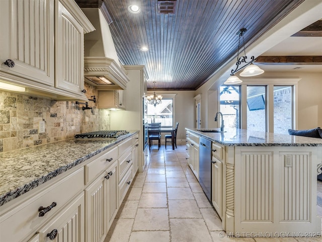 kitchen with premium range hood, an inviting chandelier, sink, hanging light fixtures, and stainless steel appliances