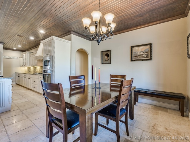 dining room with a chandelier, wooden ceiling, and ornamental molding