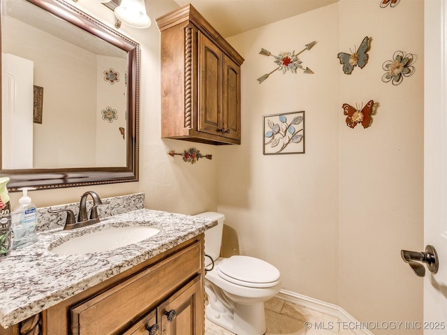 bathroom featuring tile patterned flooring, vanity, and toilet