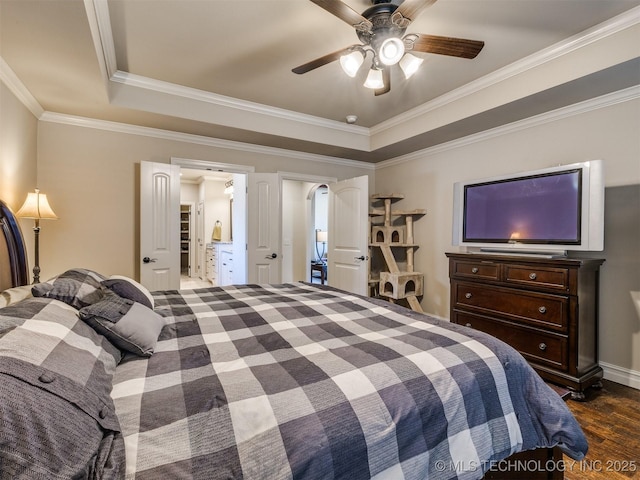 bedroom with ceiling fan, dark hardwood / wood-style flooring, a raised ceiling, and crown molding